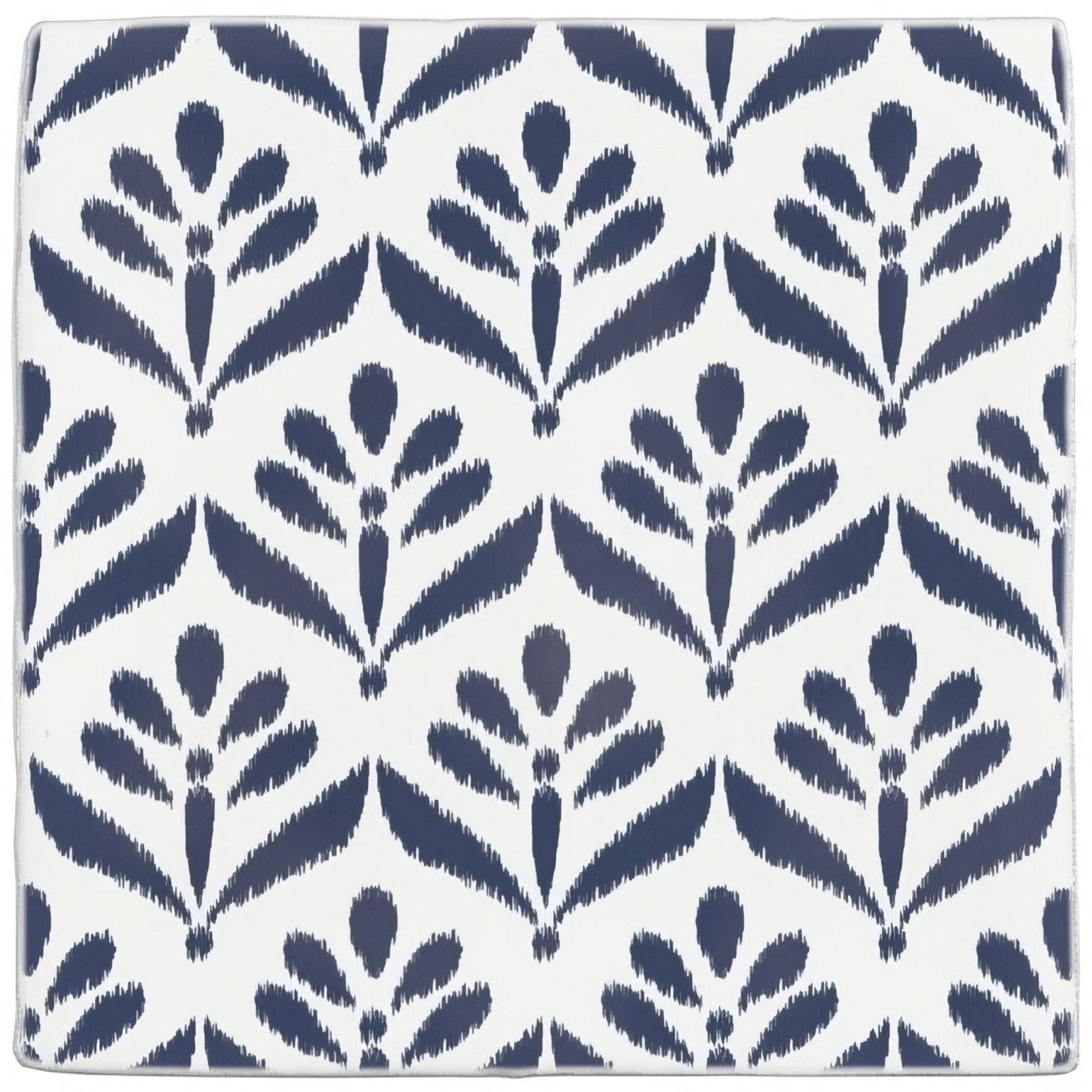 White ceramic coaster with repeating navy blue ikat-style floral pattern from jacquard indigo collection