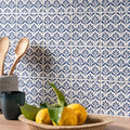 A woven jacquard indigo basket filled with bright yellow lemons and green leaves for decorative use