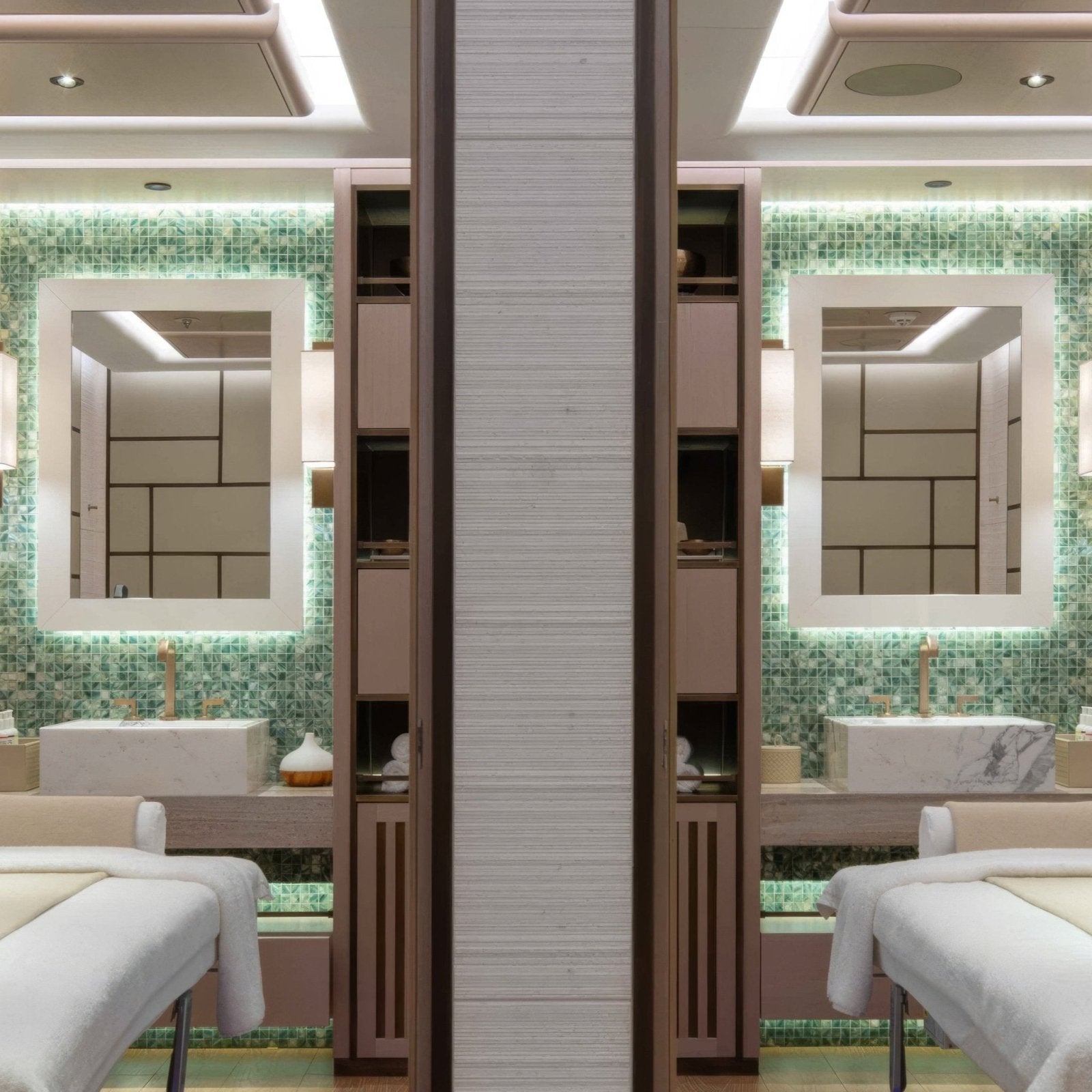 Luxury spa treatment room with two green tiled jade 25mm square vanity stations featuring white marble sinks and gold faucets