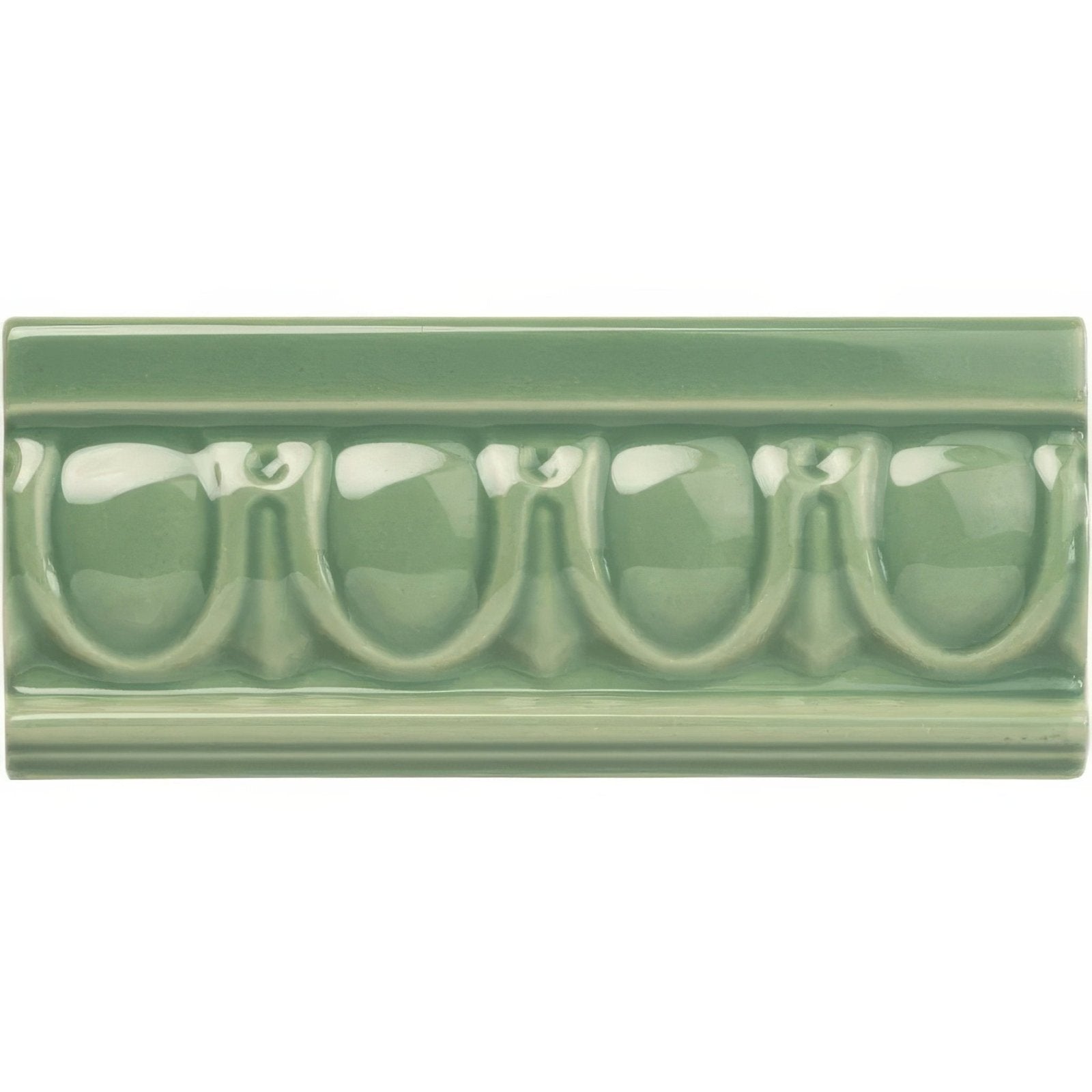 A glossy sage green ceramic tile with raised arched and leaf patterns from jade breeze egg and dart moulding