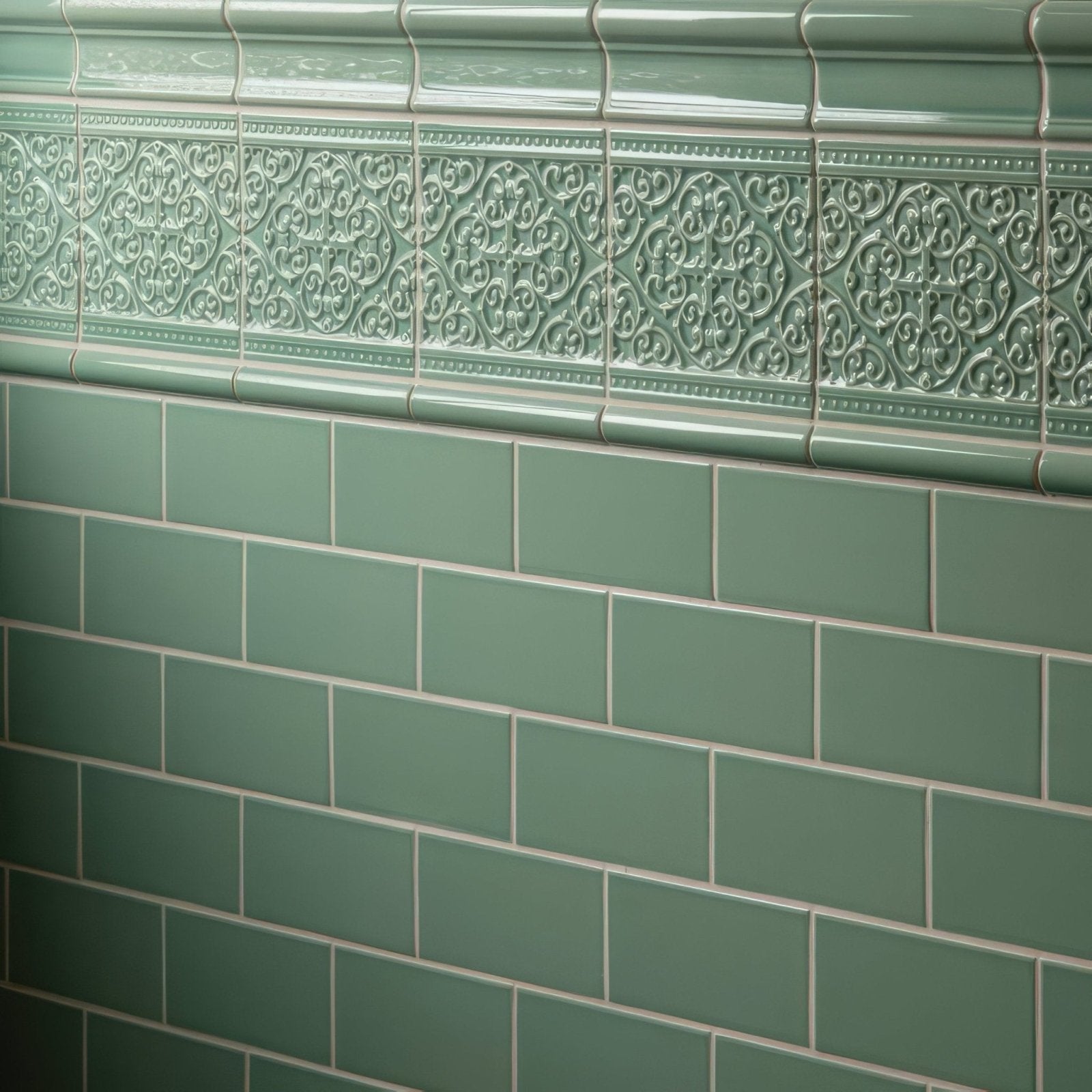 Jade breeze sigma moulding green ceramic tiles with intricate raised floral border above plain subway tiles
