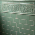 Jade breeze victoria moulding green ceramic tiles with raised floral patterns above plain subway tiles