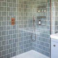 Jaipur dartmouth green rectangle glazed tile with a sleek modern brushed copper finish showerhead and curved spout