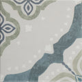 A square Jaipur Deesar patterned ceramic tile with a distressed vintage design in blue gray and olive green on light gray