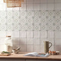 Jaipur jasmine white ceramic tiles with subtle gray and green geometric patterns on kitchen backsplash