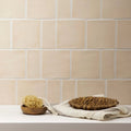 Beige ceramic subway tile with subtle texture and white grout from jaipur old ochre rectangle glazed tile collection
