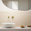 White marble bowl sink with subtle gray veining paired with jaipur old ochre rectangle glazed tile