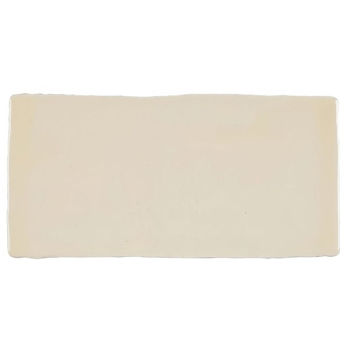 Cream-colored rectangular ceramic Jaipur Old Ochre rectangle glazed tile with slightly uneven rustic edges