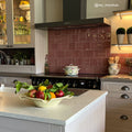 Jaipur pompeiian red rectangle glazed tile features a glossy burgundy subway tile backsplash with a subtle sheen