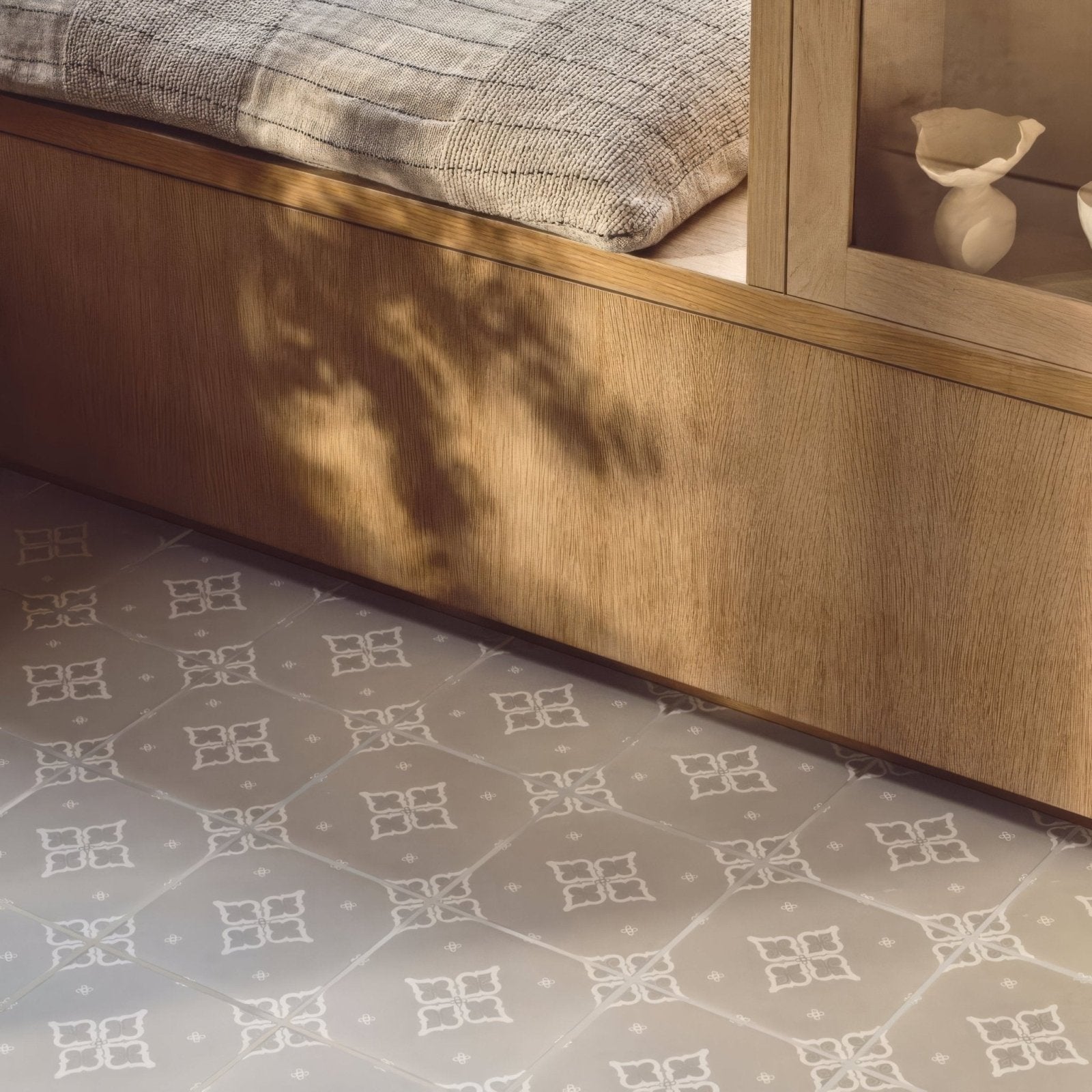Gray patterned floor tile featuring a repeating white quatrefoil design from the Jaipur Sagar collection