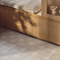 Gray patterned floor tile featuring a repeating white quatrefoil design from the Jaipur Sagar collection
