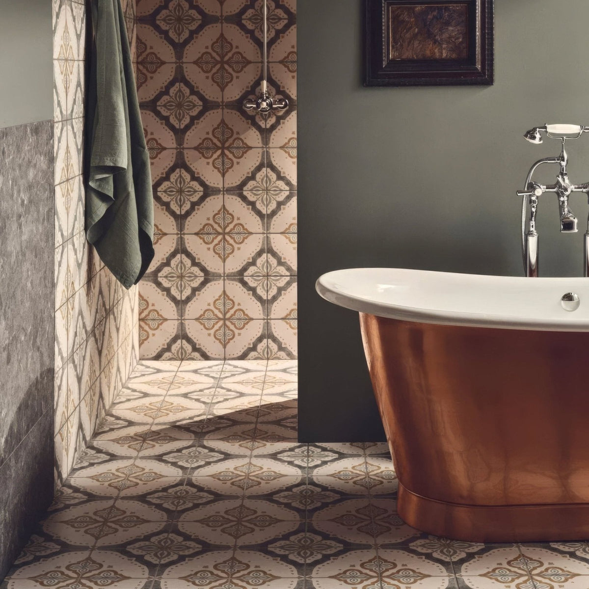 Copper freestanding bathtub with polished reflective surface and elegant curved design featured in jaipur sikkar patterned tile setting