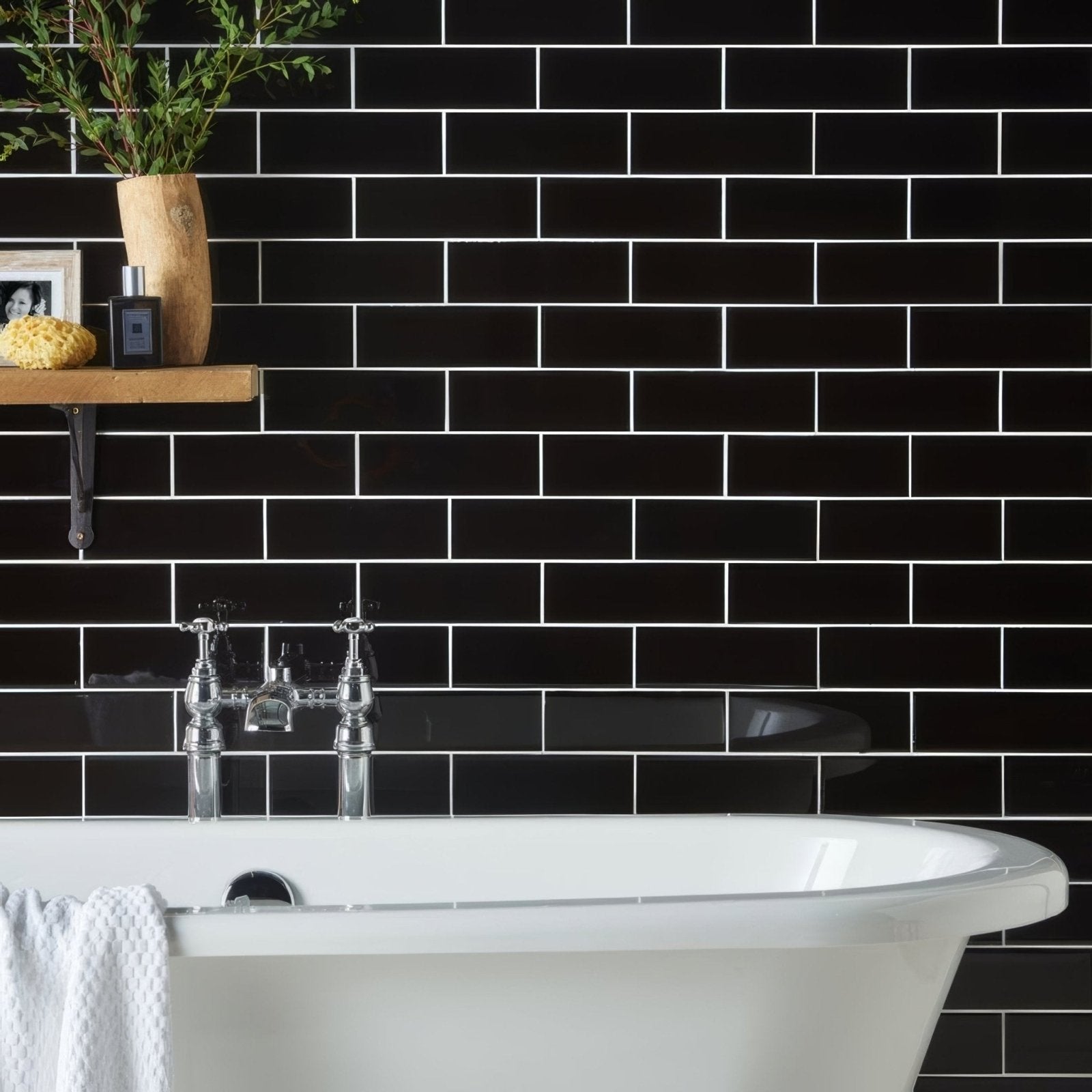 Jet black large brick black subway tile wall with white grout for modern interior design applications