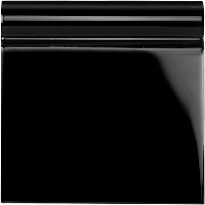 Jet black skirting tile made of glossy black ceramic with a smooth reflective surface and subtle horizontal ridges