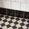 Jet black skirting tile featuring black glossy diamond-patterned tile trim for sleek wall edges and accents