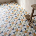 Geometric patterned kaleidoscope porcelain fritillary floor tiles in muted orange blue gray beige and white colors