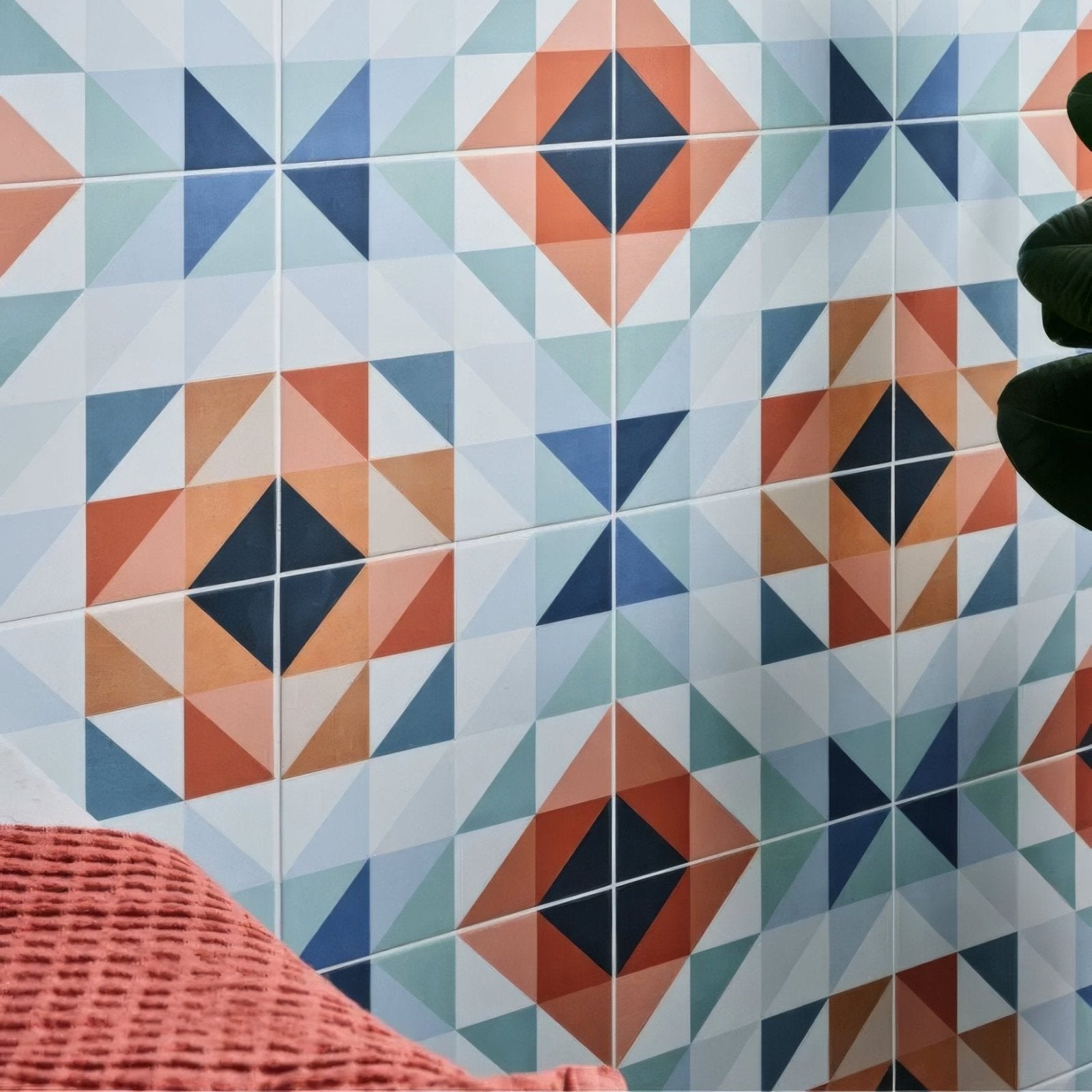 Geometric patterned kaleidoscope porcelain peacock wall tiles with orange blue and white triangular shapes in modern design
