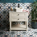 Kaleidoscope porcelain skipper white hexagonal ceramic sink with black faucet on cream vanity cabinet