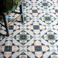 Kaleidoscope porcelain skipper floor tiles with navy blush pink gray and white geometric triangle pattern
