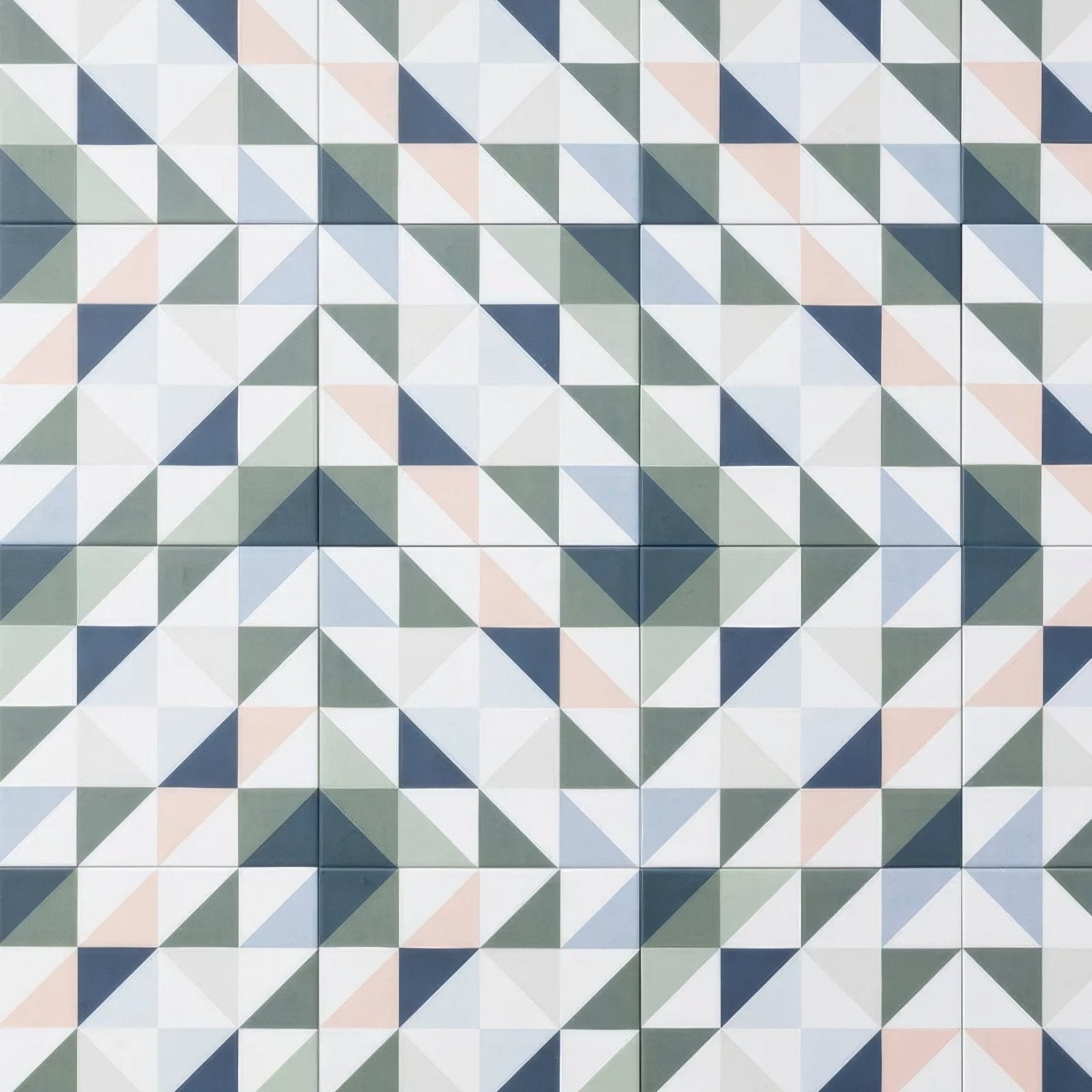 Geometric patterned kaleidoscope porcelain skipper tile with interlocking triangles in white gray navy blue and peach tones