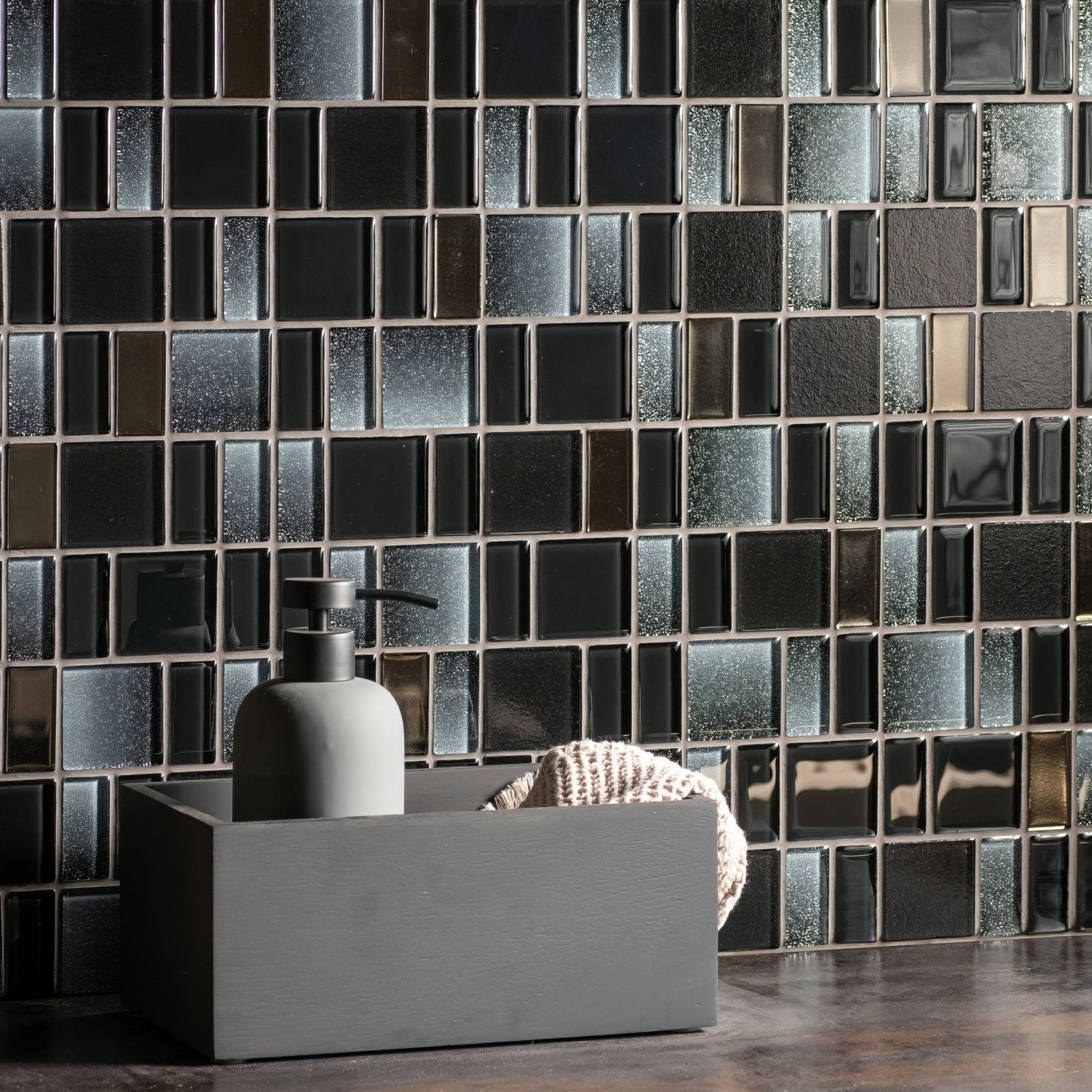 Kamino Rectangle Mix Mosaics black and silver glass mosaic with a grey soap dispenser in a tray