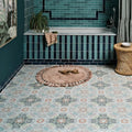 A round beige tasseled Kashmir Porcelain Earthern rug with soft texture and muted floral patterns in green pink and blue