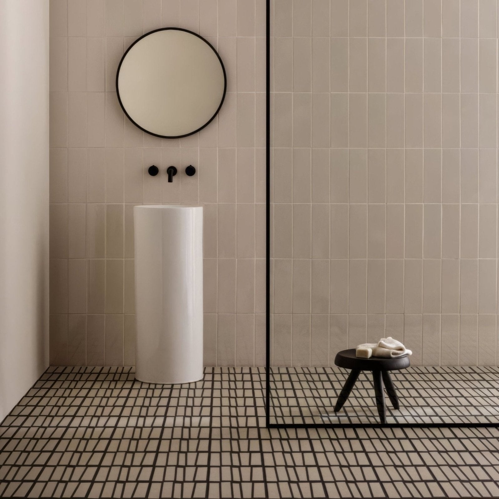 Minimalist white ceramic pedestal sink with sleek cylindrical form from Kelly Hoppen Strip beige and black collection