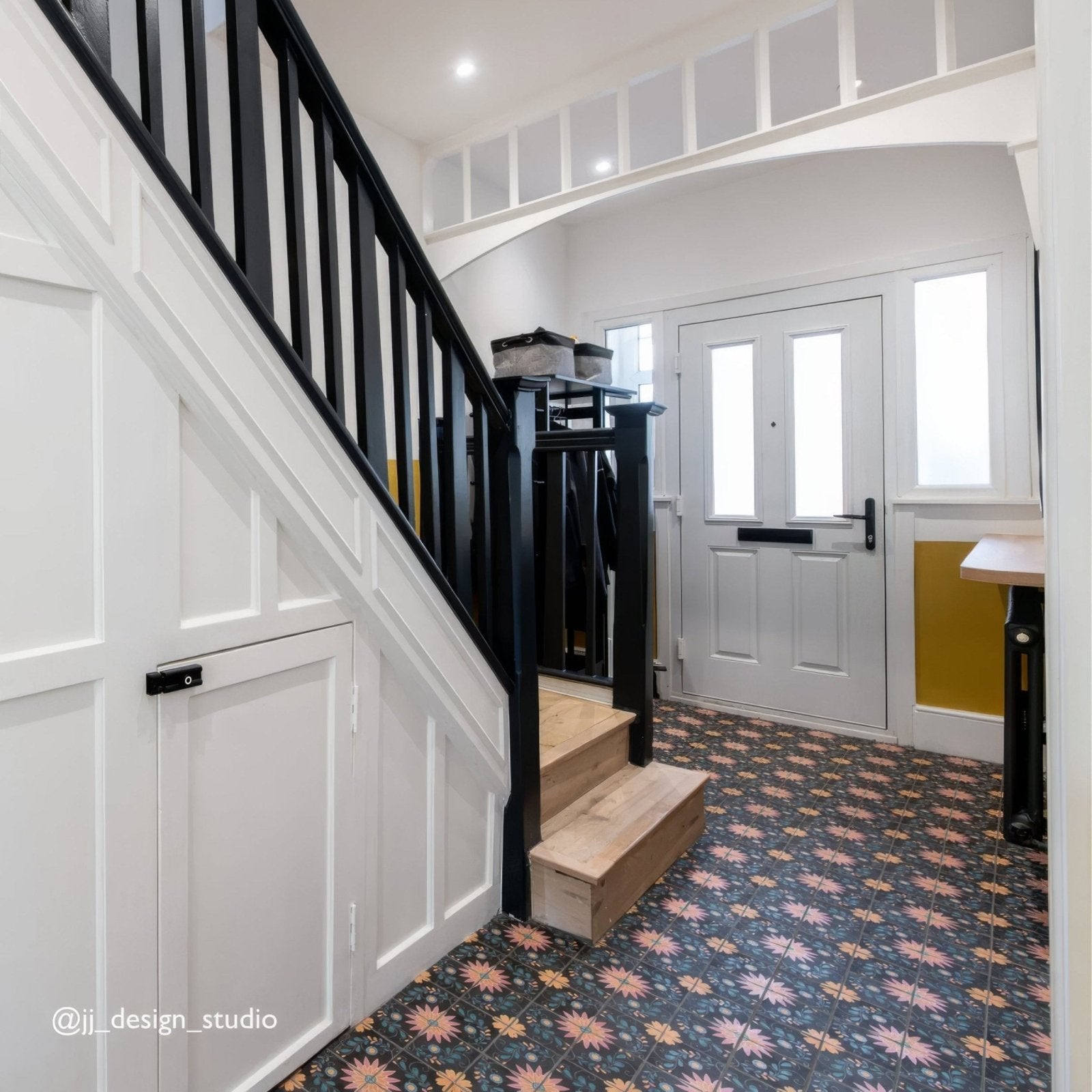 White front door with two vertical frosted glass panels and black mail slot featured with kelmscott blackwell patterned tile