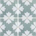 Kelmscott coleton blue patterned square tiles with a white floral motif on a muted sage green background