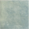 A square kelmscott green tile with a muted sage green textured finish and subtle white speckles