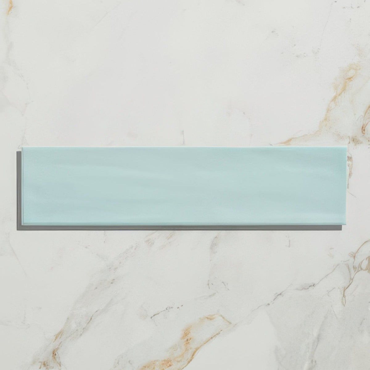 A sleek rectangular mint green glass tile with a subtle glossy finish from kennet porcelain aqua collection