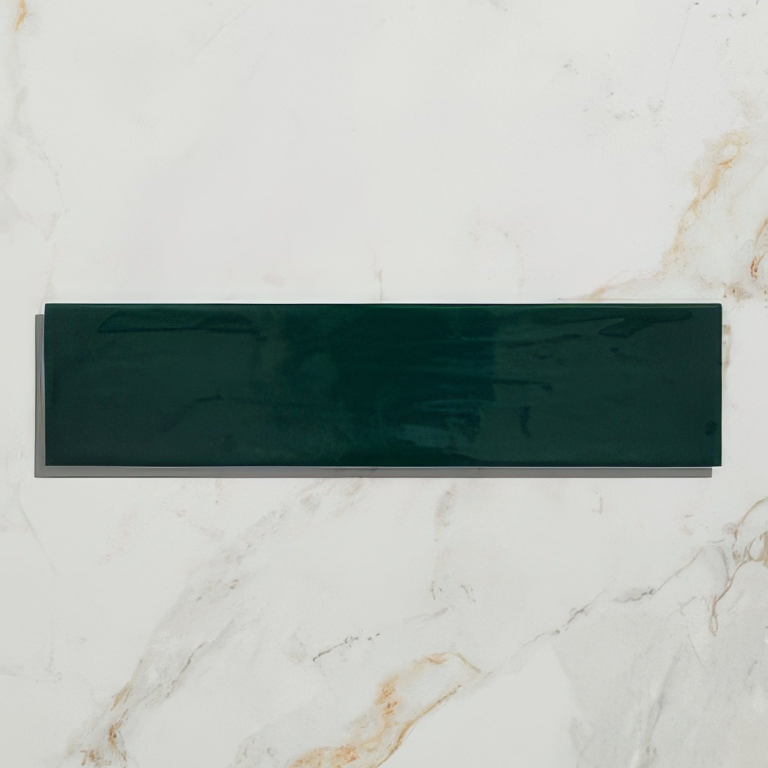 A sleek glossy dark green rectangular kennet porcelain bottle green tile with a smooth reflective surface