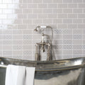 Polished silver bathtub kew on dunwich with classic faucet and white towel draped over its edge