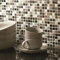 Khois Mosaic dark grey, silver and copper mosaic with a stack of beige coffee cups