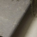 Kimmeridge limestone etched bullnose coping in gray textured fabric with a subtle speckled finish