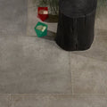 Gray stone-effect floor tiles with subtle texture and natural veining in kimmeridge limestone etched finish