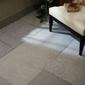Beige kimmeridge limestone etched finish stone tiles with natural texture and tone variations arranged as floor surface