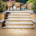 Stone steps with kimmeridge limestone paving tumbled and etched finish in light gray with sturdy brick sides