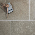 Kimmeridge limestone tumbled and etched gray stone tiles with subtle veining and a matte finish
