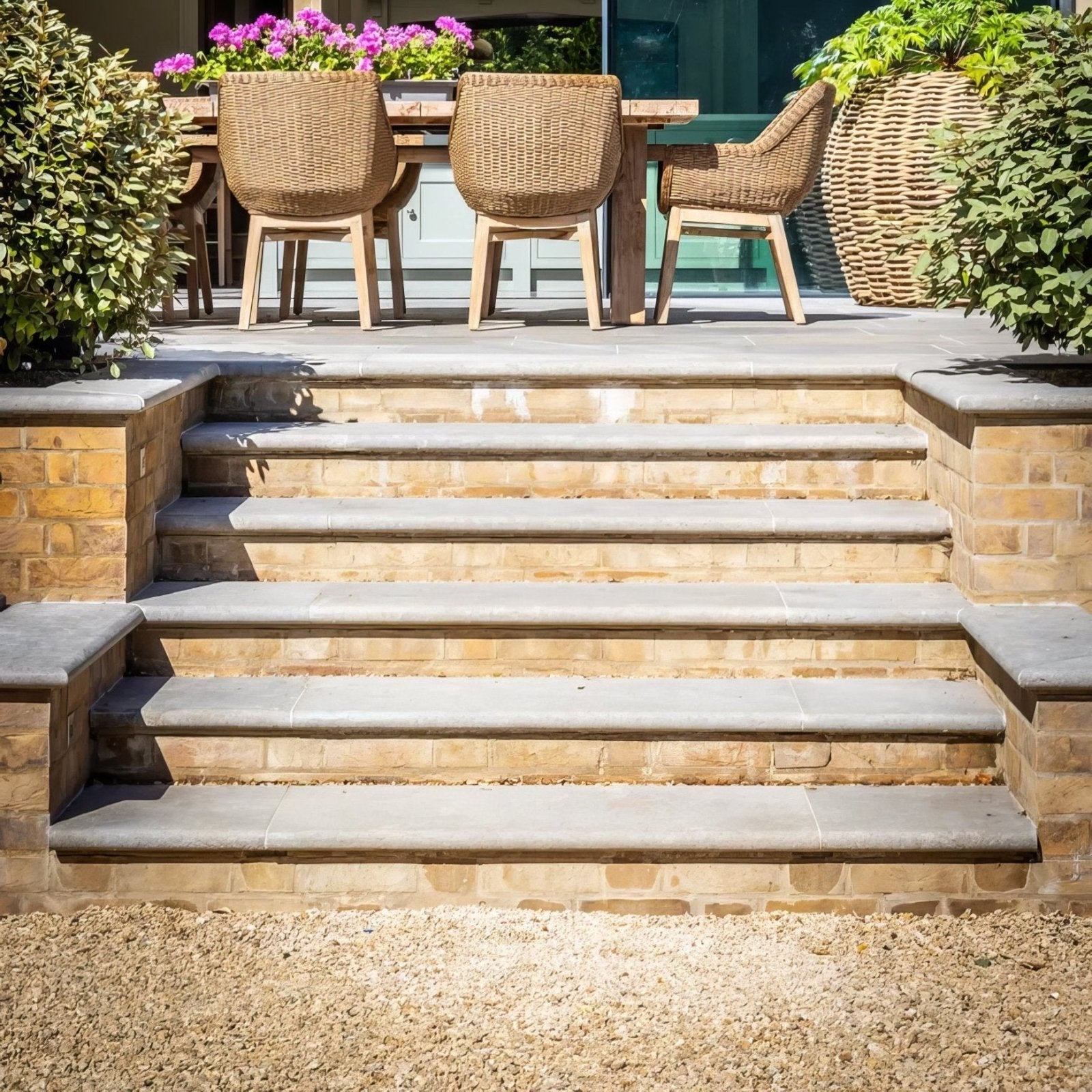Stone steps with kimmeridge limestone tumbled and etched finish in light gray with beige brick sides