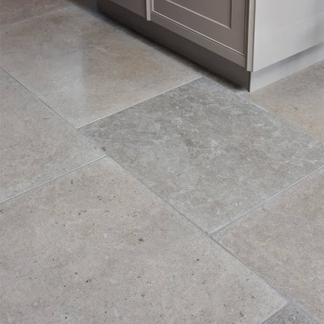 Beige and gray kimmeridge limestone tumbled finish stone tiles with subtle natural veining pattern