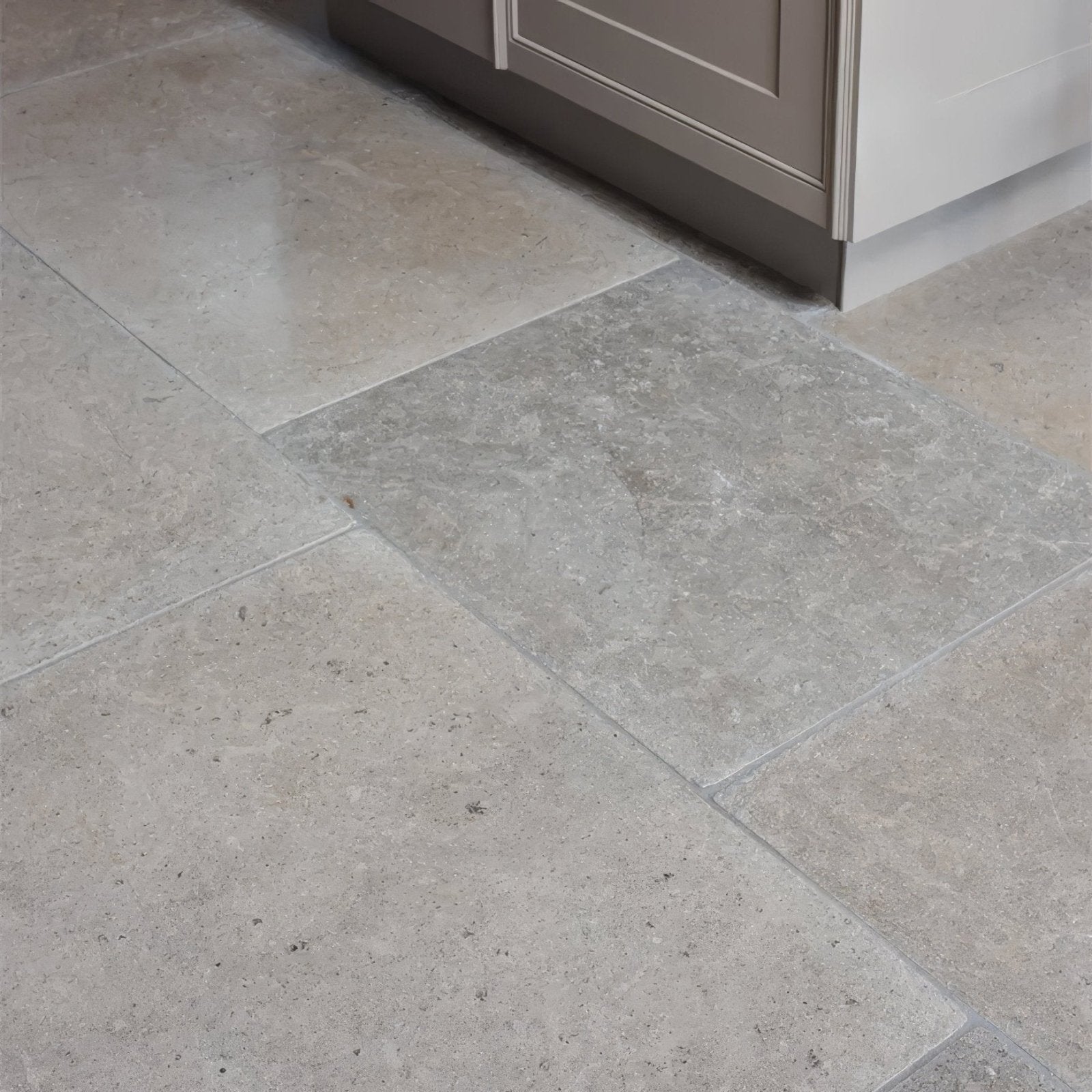 Beige and gray kimmeridge limestone tumbled finish stone tiles with subtle natural veining pattern