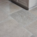 Beige and gray kimmeridge limestone tumbled finish stone tiles with subtle natural veining pattern