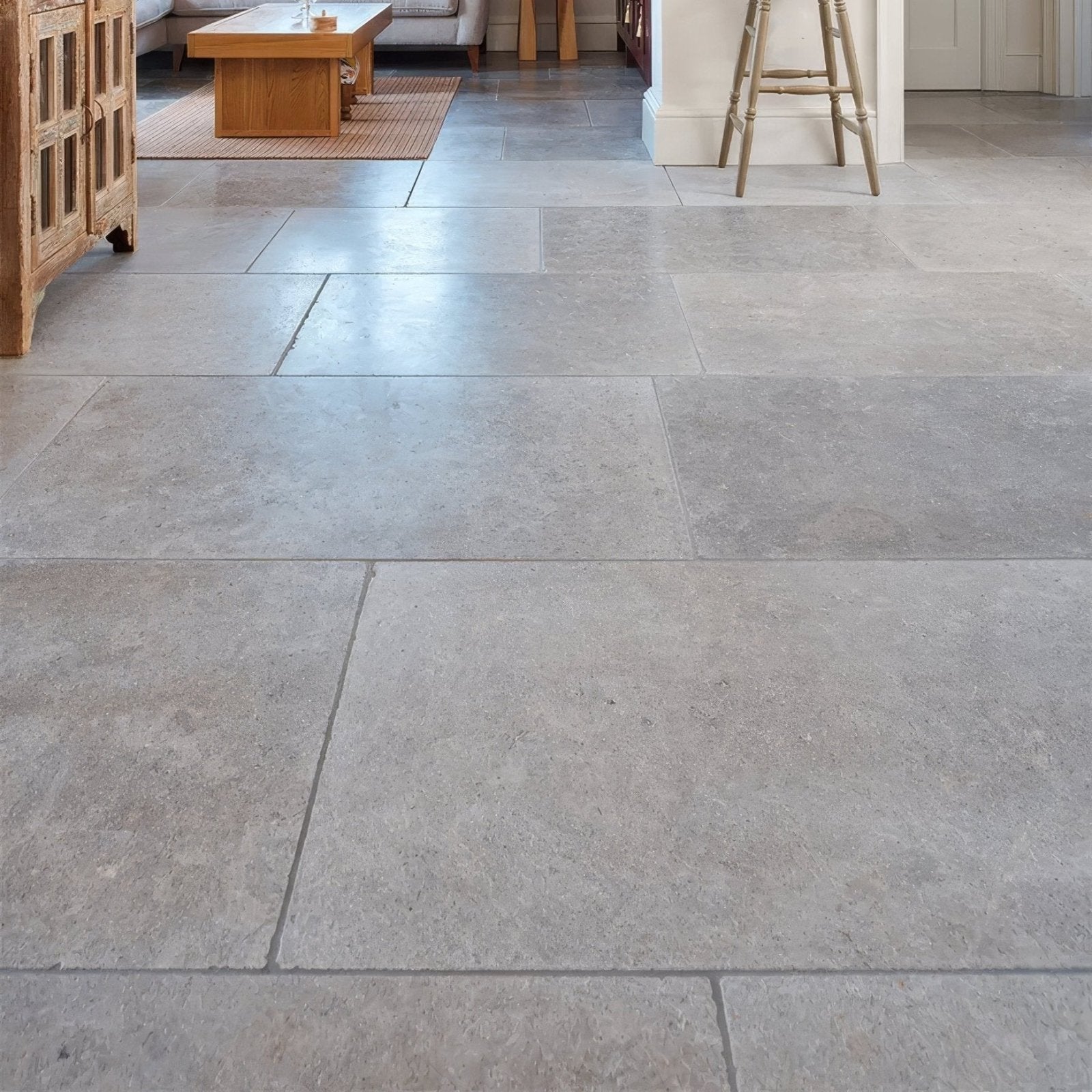 Gray kimmeridge limestone tumbled finish stone tiles with a natural textured surface for flooring and walls