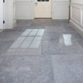 Gray kimmeridge limestone tumbled finish tiles with subtle veining pattern covering the floor