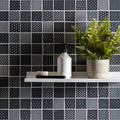 Kinetic Black Recycled Glass black and white patterned glass mosaic with a white soap dispenser on a shelf