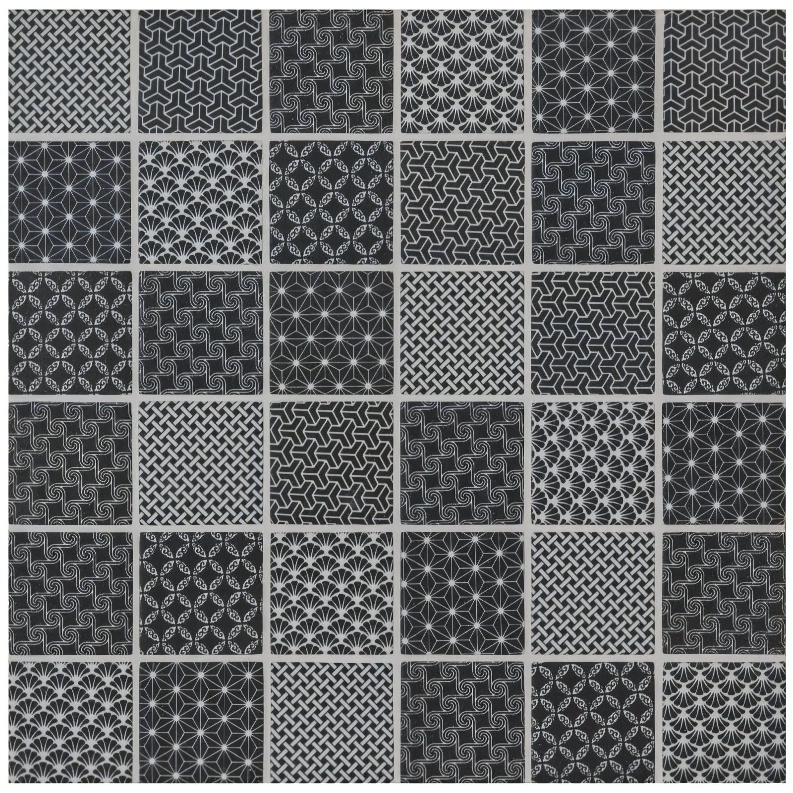 A collection of twenty-five black and white geometric pattern tiles made from kinetic black recycled glass