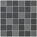 A collection of twenty-five black and white geometric pattern tiles made from kinetic black recycled glass