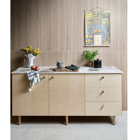 Kinfolk Porcelain Maple light wood-effect porcelain tiles with a sideboard and marble top
