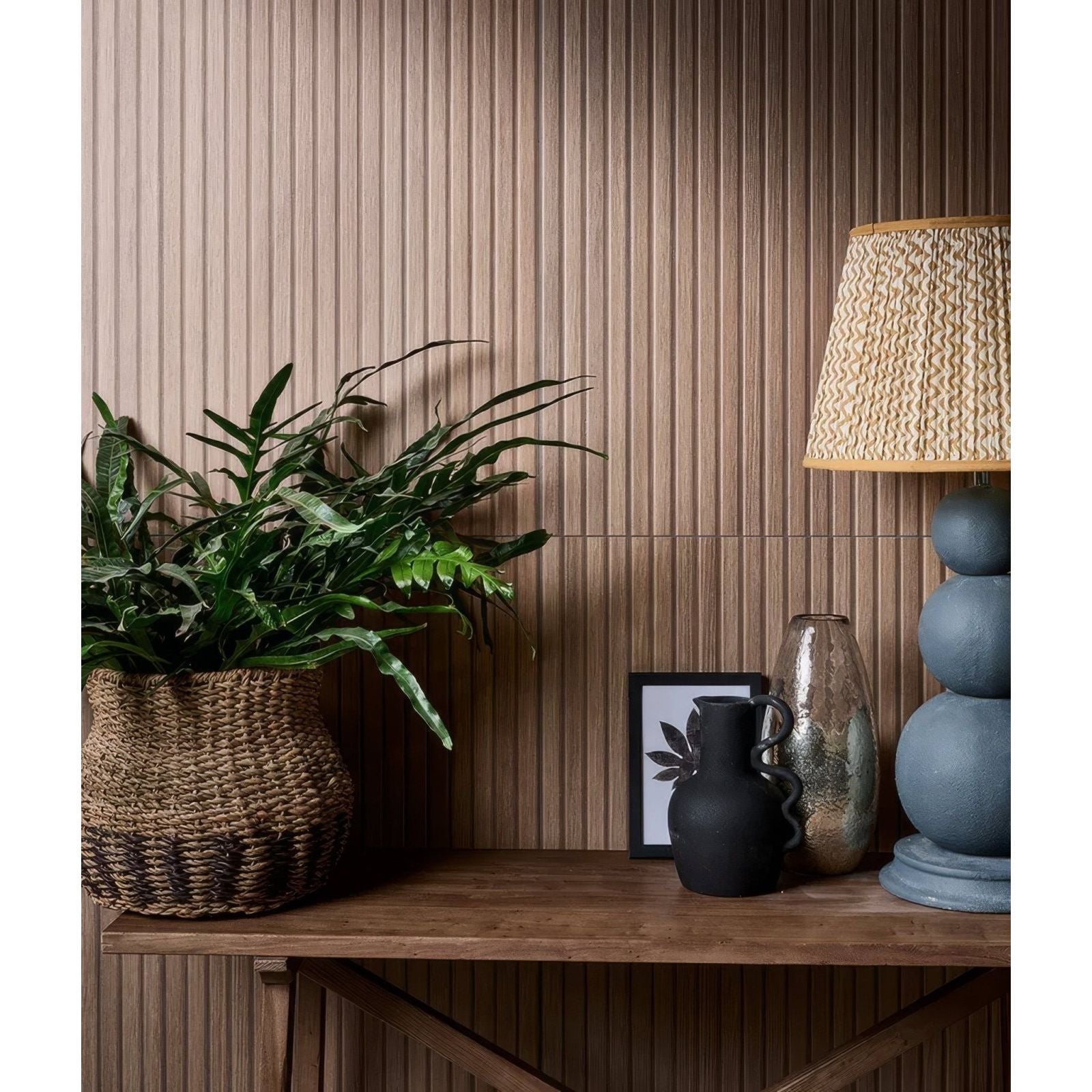 Woven brown basket holding lush green fern plant featuring kinfolk porcelain nut design